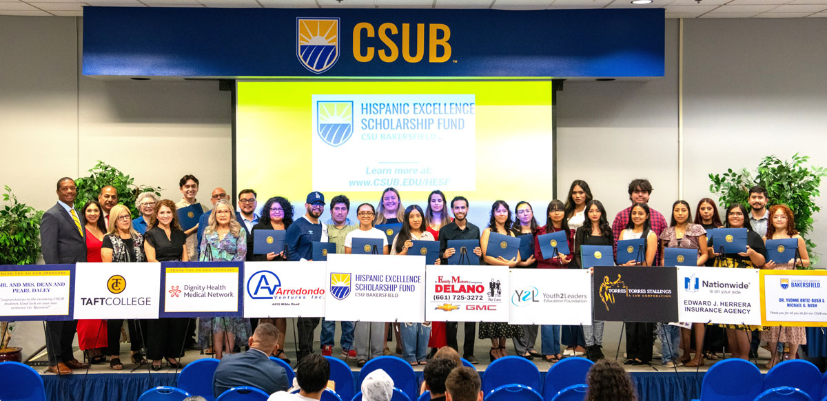 Group of HESF students holding up signs