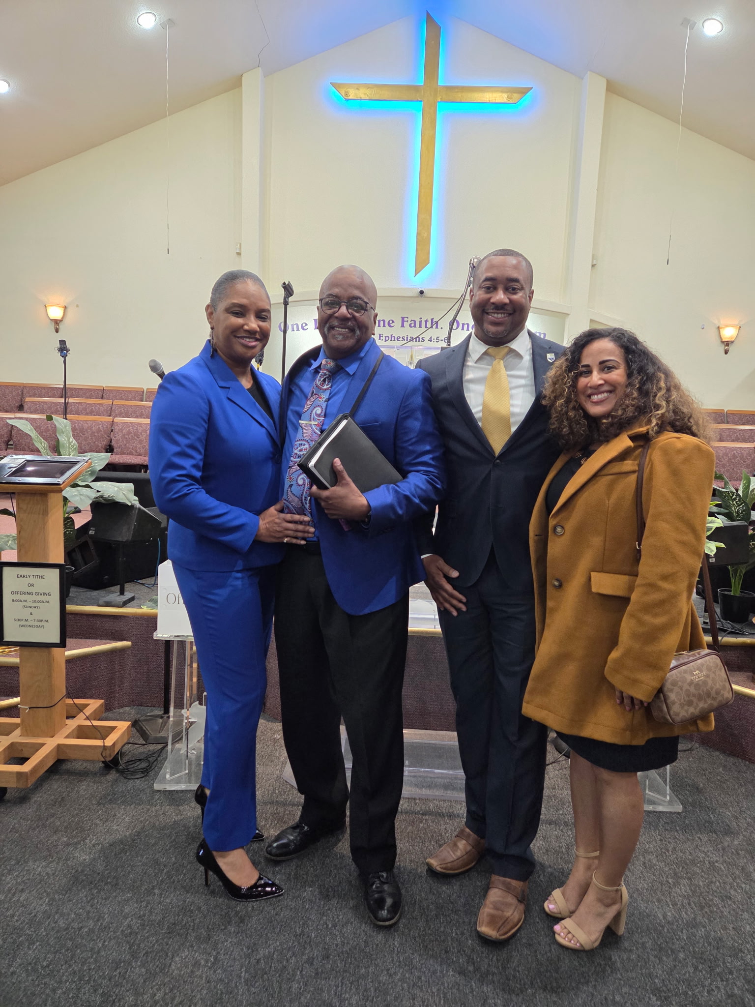group staniding in front of a cross