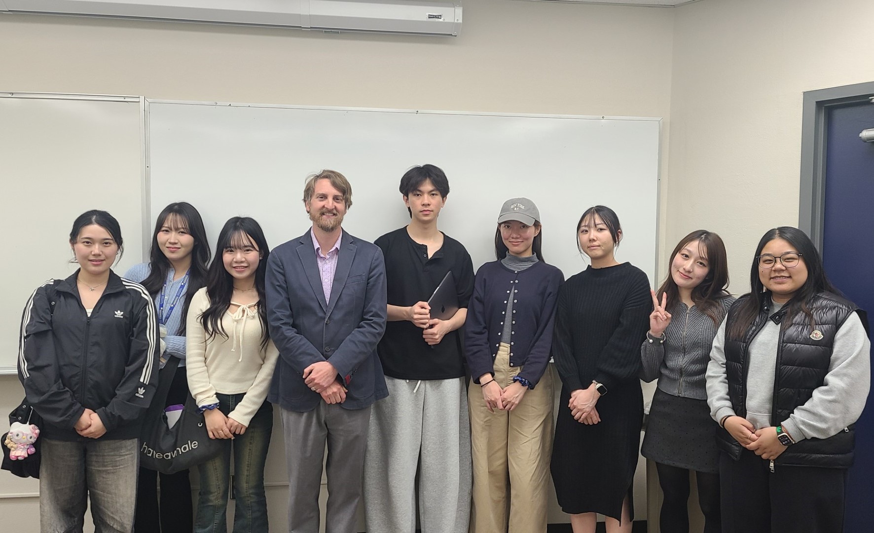 Students standing with Dr. Henderson in SOC 4008