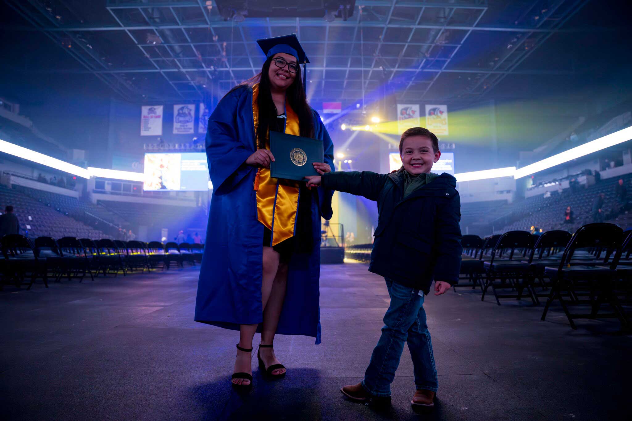 Graduate with child at commencement